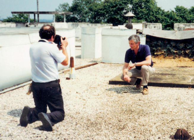 A BBC TV crew member films Snepp in 1991 on the roof of the U.S. Embassy in Saigon for a documentary. PHOTO: COURTESY FRANK SNEPP ’65, ’68 SIPA
